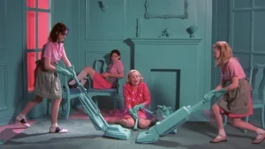 Girls dressed in pink, vacuuming